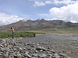 Tibet Kailash 05 To Tirthapuri 03 Peter throwing rocks just past Hor Qu We drove just past Hor Qu and had our lunch next to a small river, while we waited for the truck. Pete took the opportunity to thrown some rocks into the river.